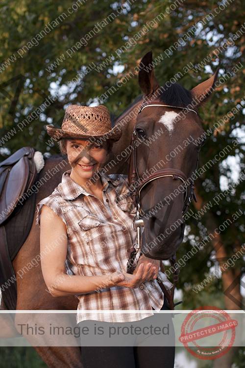 Young woman hold horses head